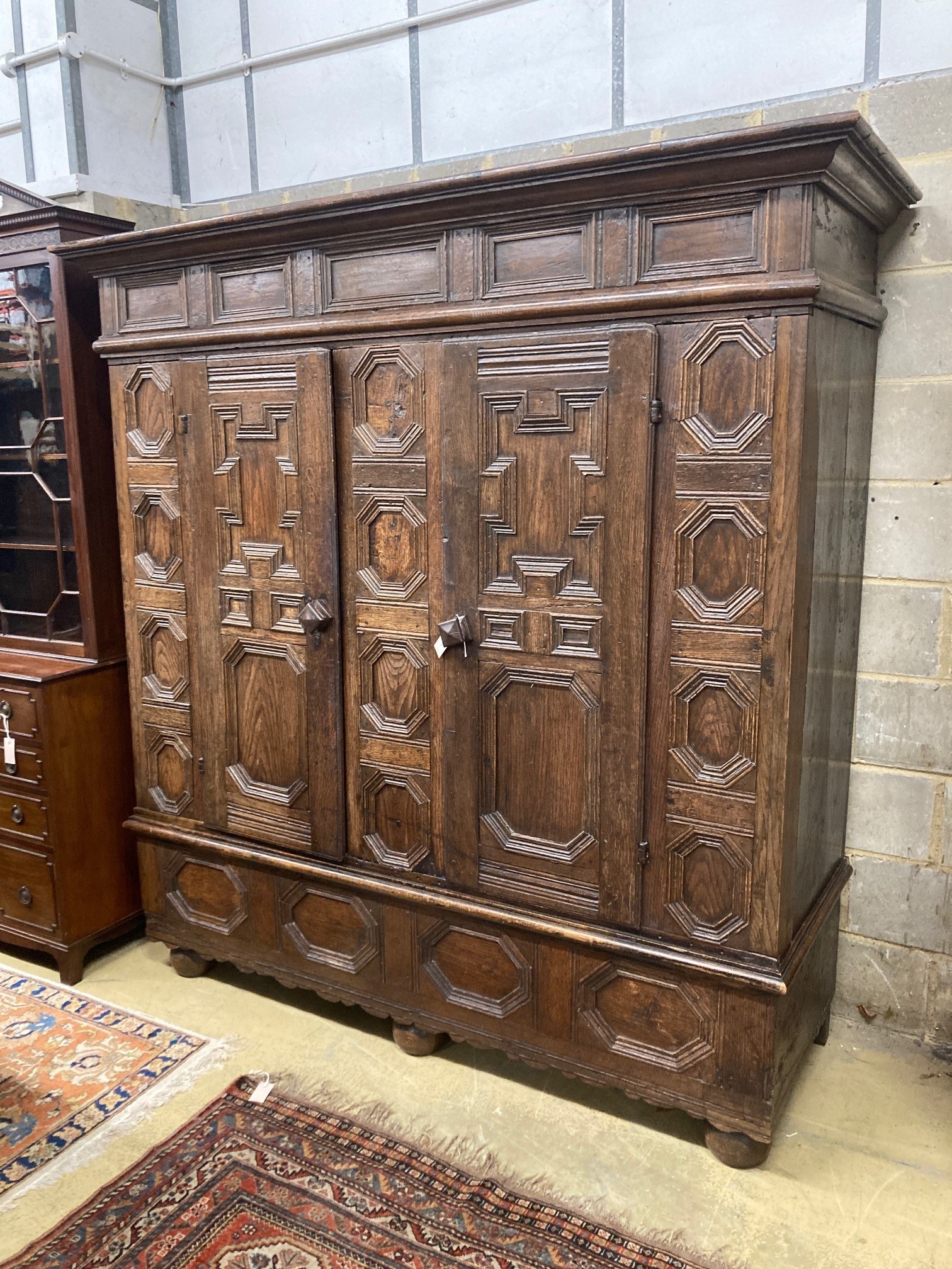 A 17th century and later panelled oak cupboard, length 194cm, depth 70cm, height 198cm